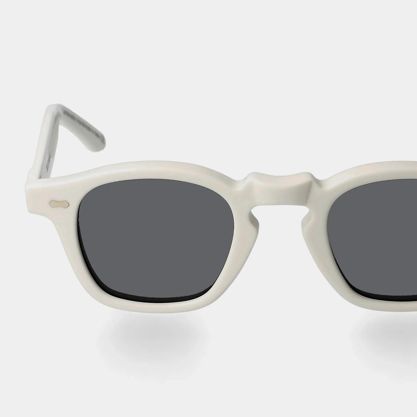 Sunglasses with white frame and dark lenses on a light gray background. - Dei Duchi (TBD Eyewear)