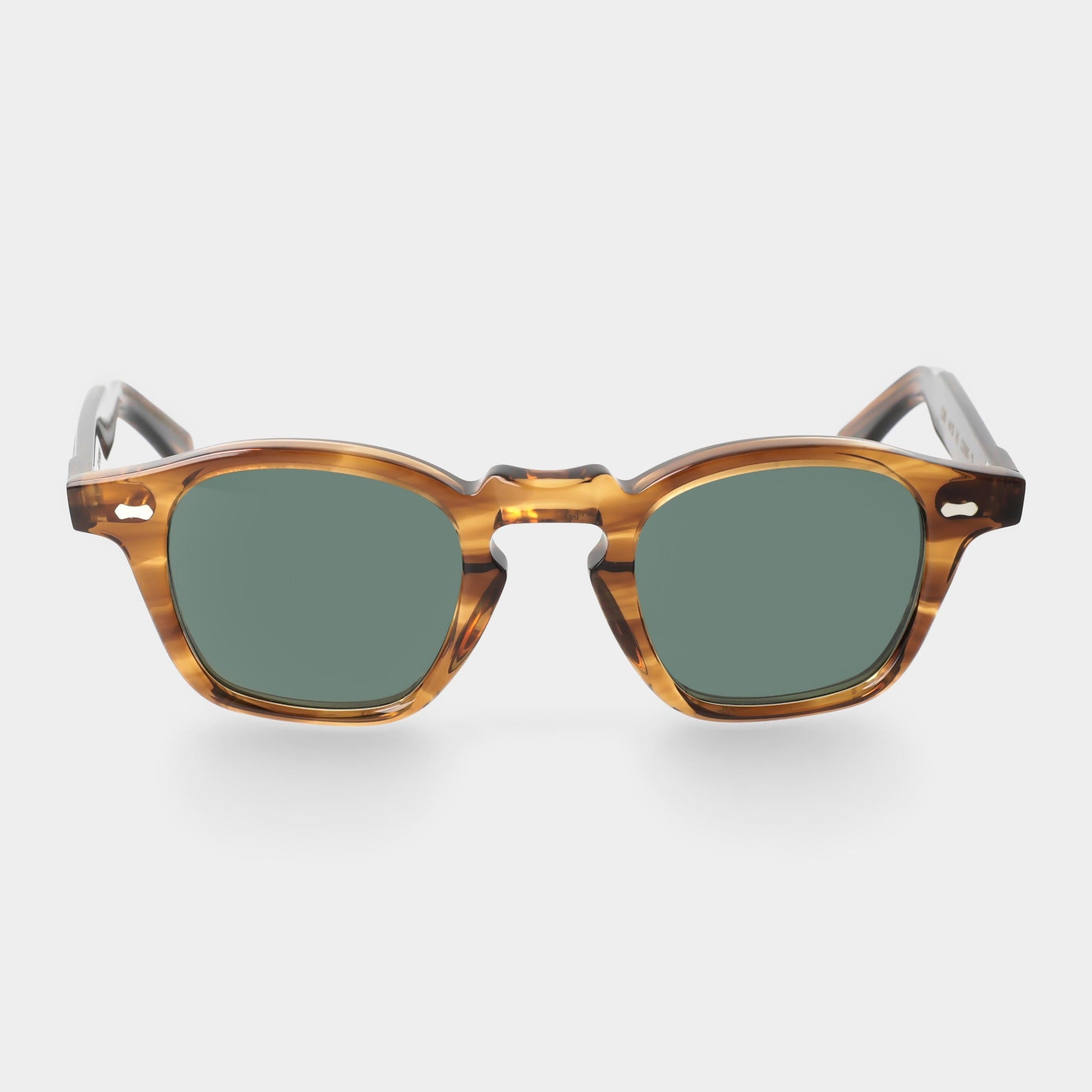 Sunglasses with tortoiseshell frame and green lenses on a white . -background - Dei Duchi