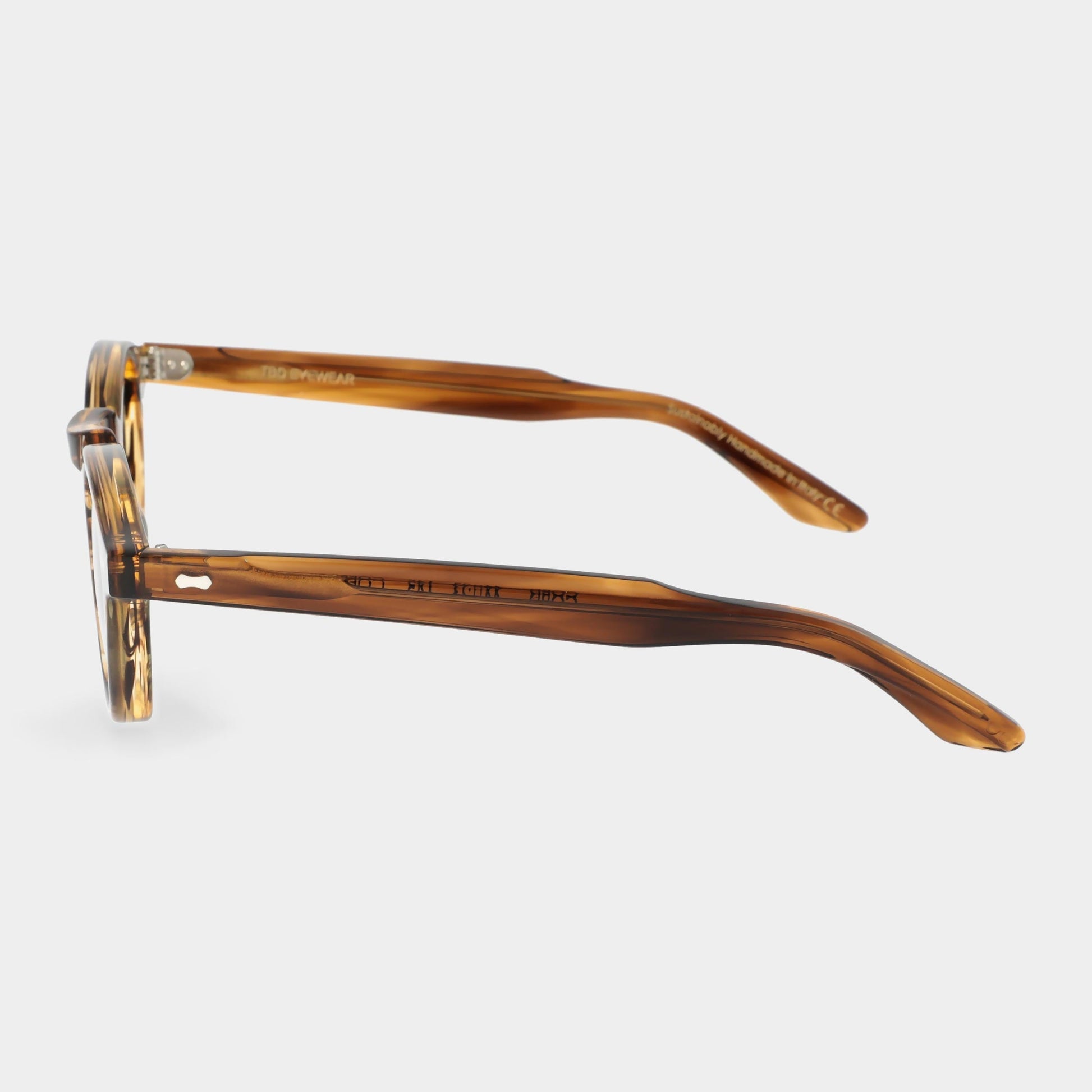 Brown tortoiseshell eyeglasses on a light gray background. - Dei Duchi