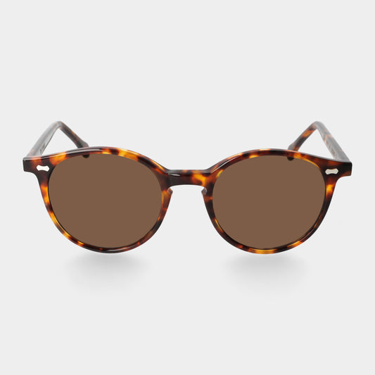 Sunglasses with tortoiseshell frame and brown lenses on a light gray background. - DEI DUCHI