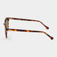 Sunglasses with tortoiseshell frame and brown lenses on a light gray background. - DEI DUCHI