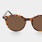 Sunglasses with tortoiseshell frame and brown lenses on a light gray background. - DEI DUCHI