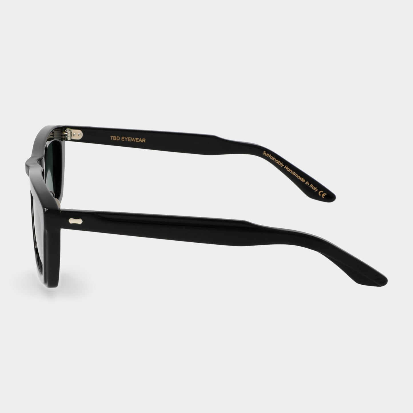 Black sunglasses with green lenses on a light gray background. - Dei Duchi
