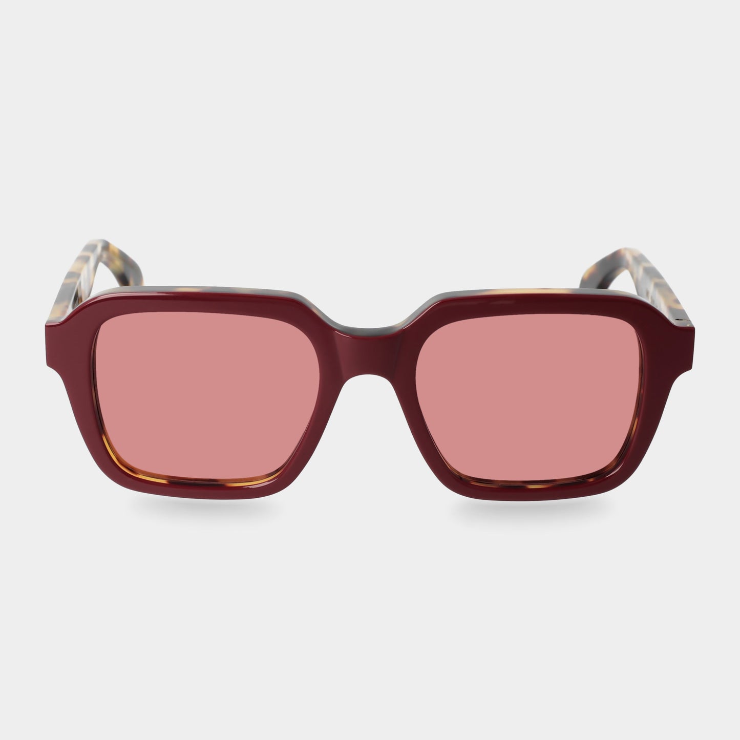 Sunglasses with red-tinted lenses on a light gray background. - Dei Duchi
