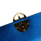 Blue textured leather handbag with a gold Amaltea emblem clasp buckle, with leather handle & strap, on a white background. - DEI DUCHI (AMALTEA)