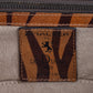 Close-up of a bag with 'Amaltea' branding and tiger pattern. -DEI DUCHI (AMALTEA)