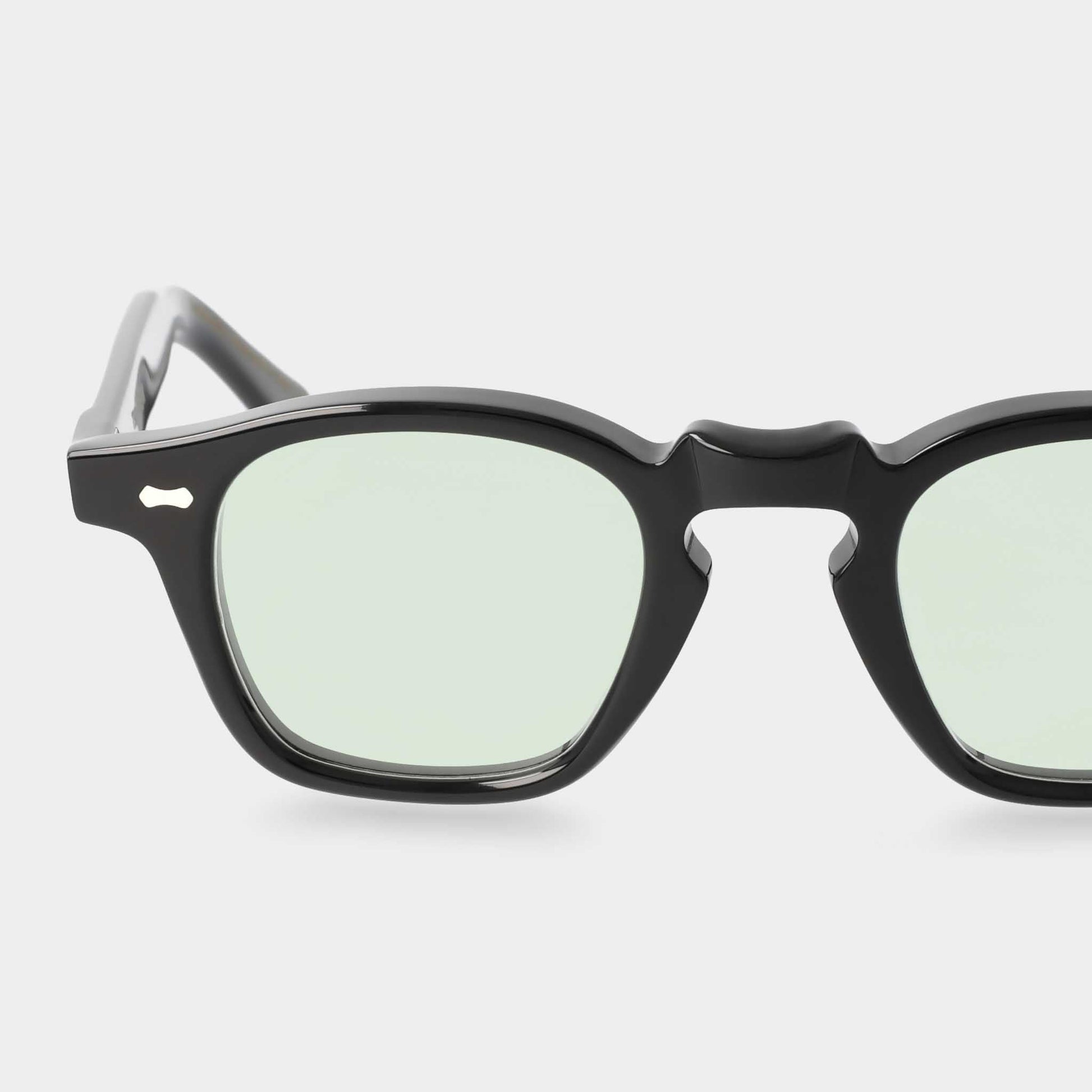 Black-framed sunglasses with light green lenses on a white background - Dei Duchi