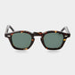 Sunglasses with tortoiseshell frame and green lenses on a light gray background. - Dei Duchi
