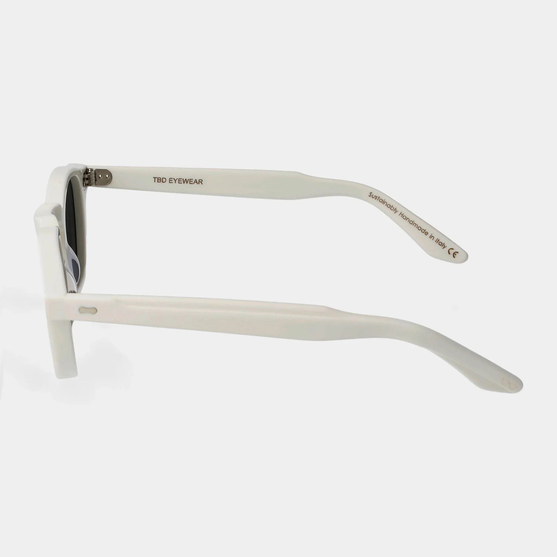 Sunglasses with white frame and dark lenses on a light gray background. - Dei Duchi (TBD Eyewear)