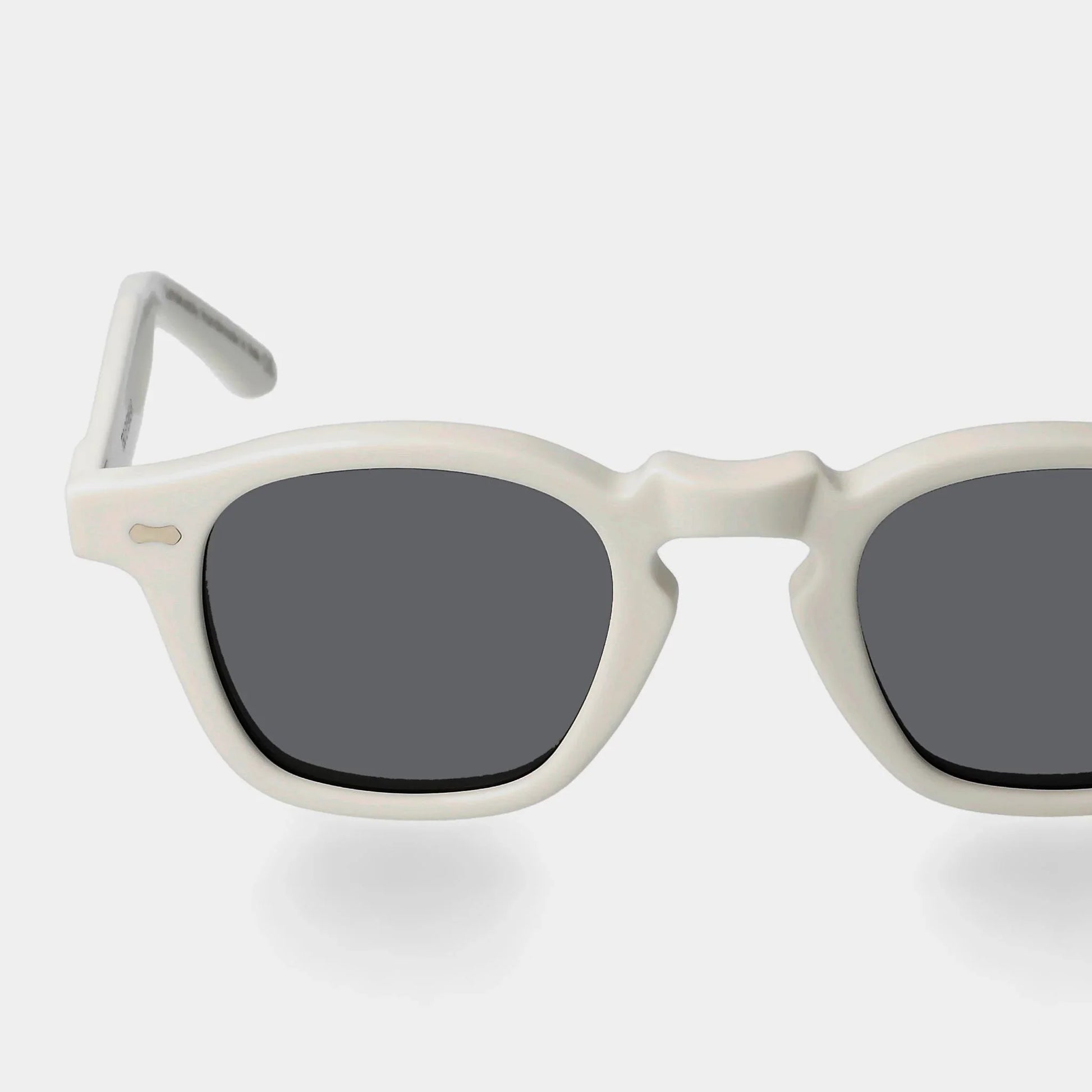 Sunglasses with white frame and dark lenses on a light gray background. - Dei Duchi (TBD Eyewear)