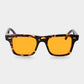 Sunglasses with tortoiseshell frame and orange lenses on a light gray background. - DEI DUCHI