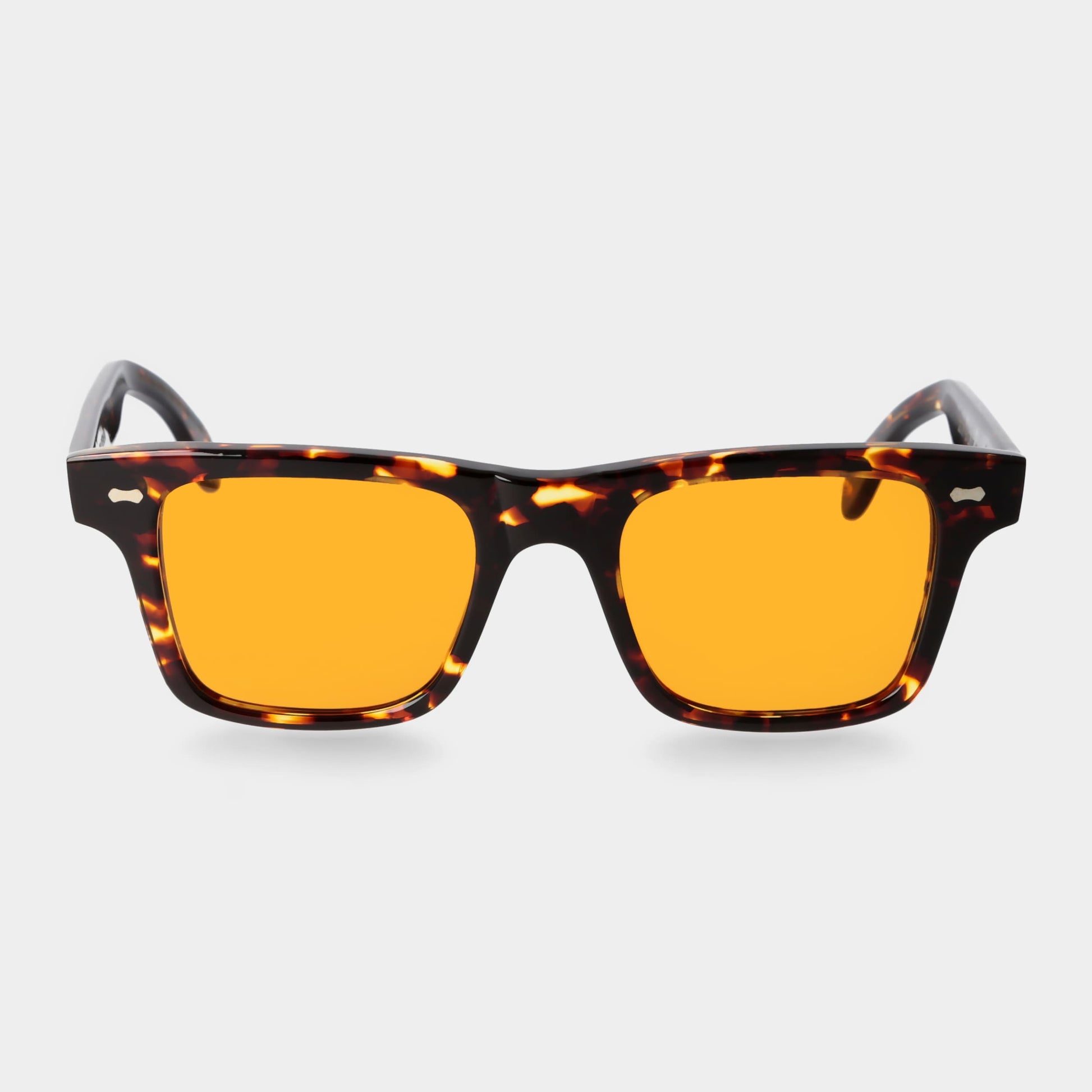 Sunglasses with tortoiseshell frame and orange lenses on a light gray background. - DEI DUCHI