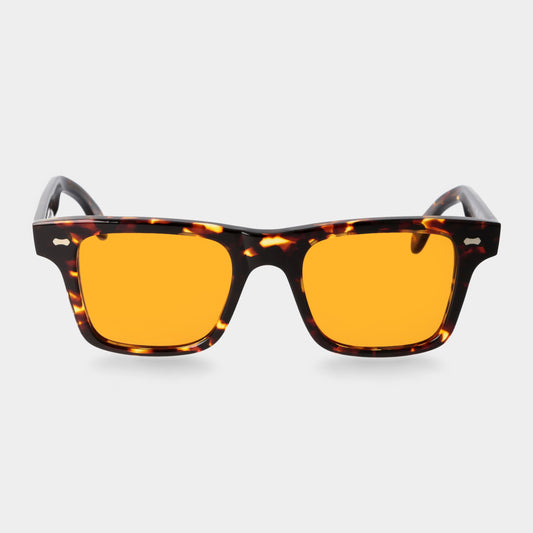 Sunglasses with tortoiseshell frame and orange lenses on a light gray background. - DEI DUCHI