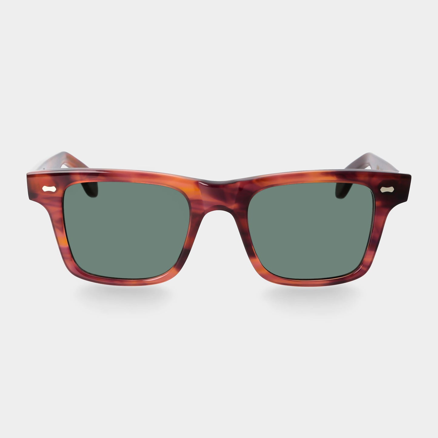Sunglasses with tortoiseshell frame and green lenses on a light gray background. - DEI DUCHI