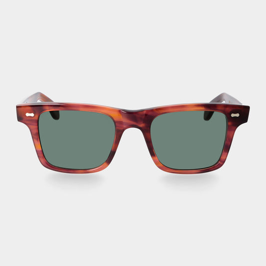 Sunglasses with tortoiseshell frame and green lenses on a light gray background. - DEI DUCHI