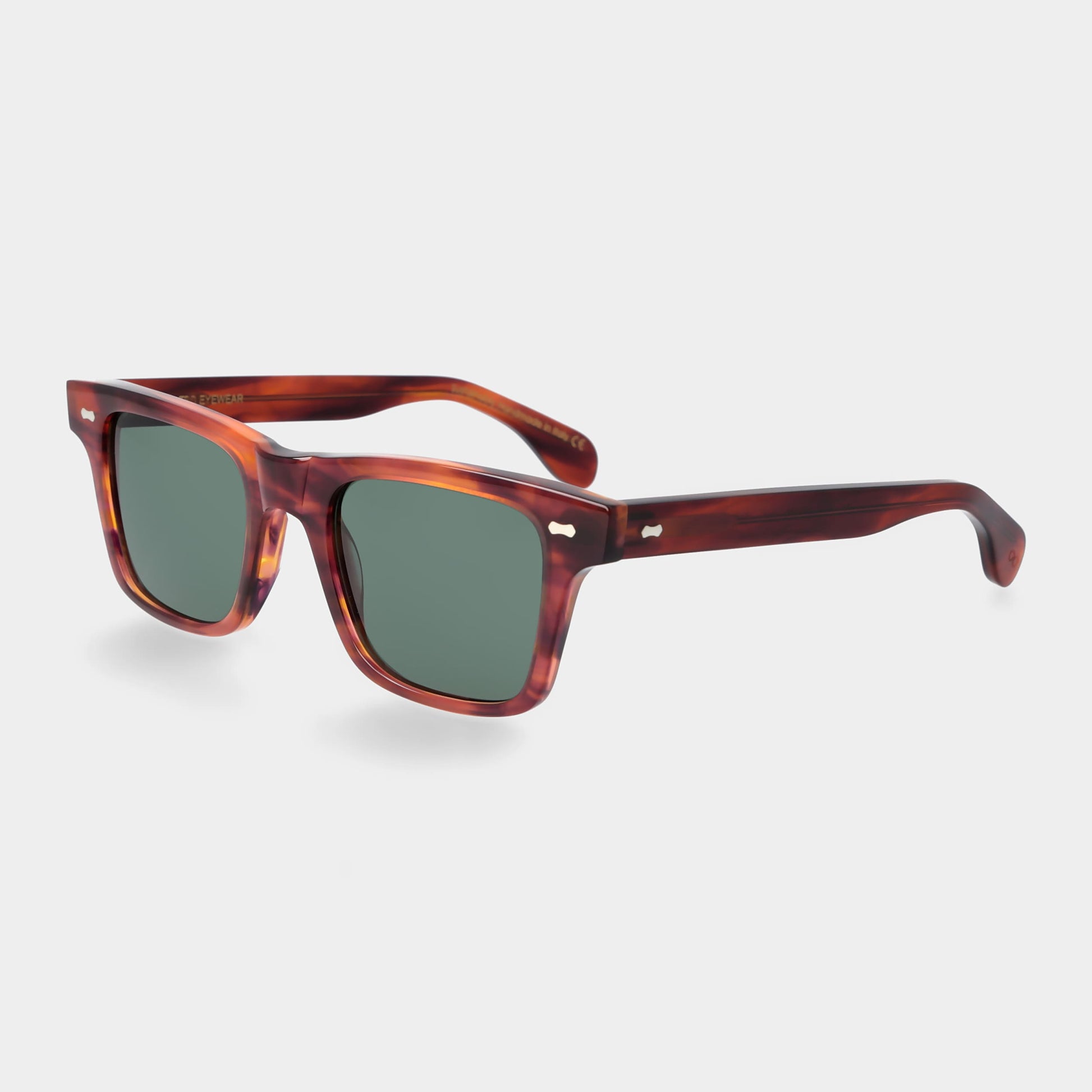 Sunglasses with tortoiseshell frame and green lenses on a light gray background. - DEI DUCHI