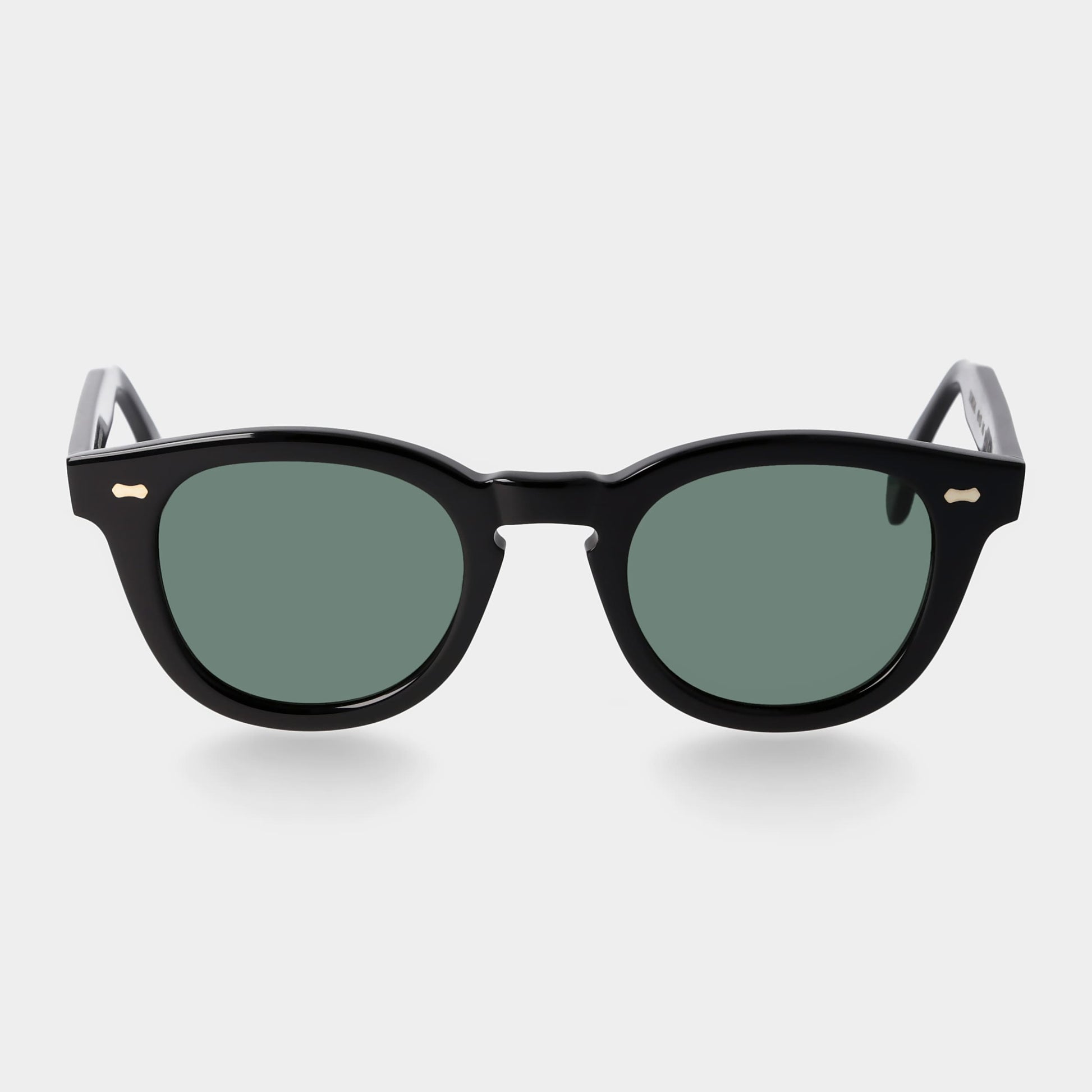 Black sunglasses with green lenses on a white background. - DEI DUCHI