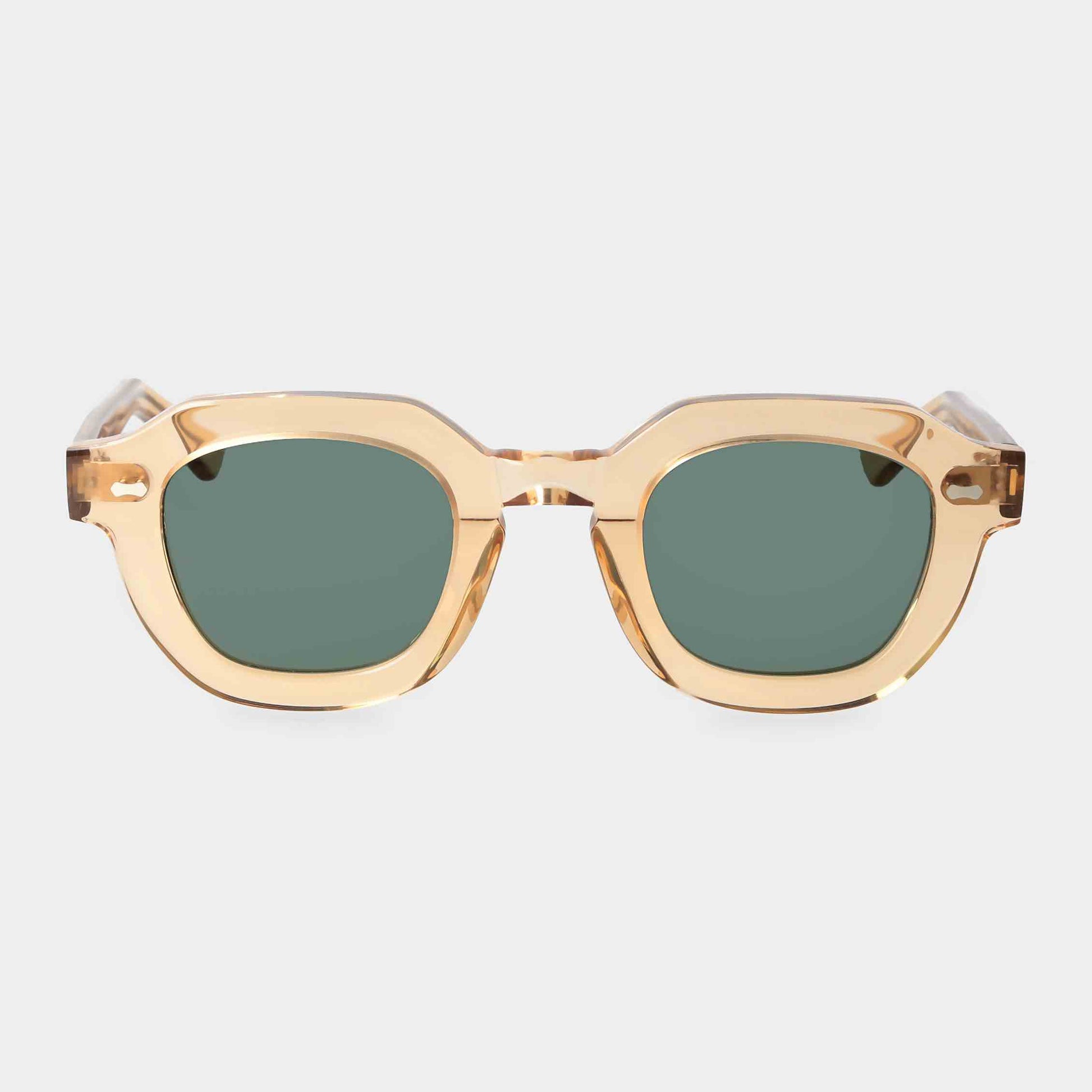 Gold-framed sunglasses with green lenses on a light gray background - Dei Duchi
