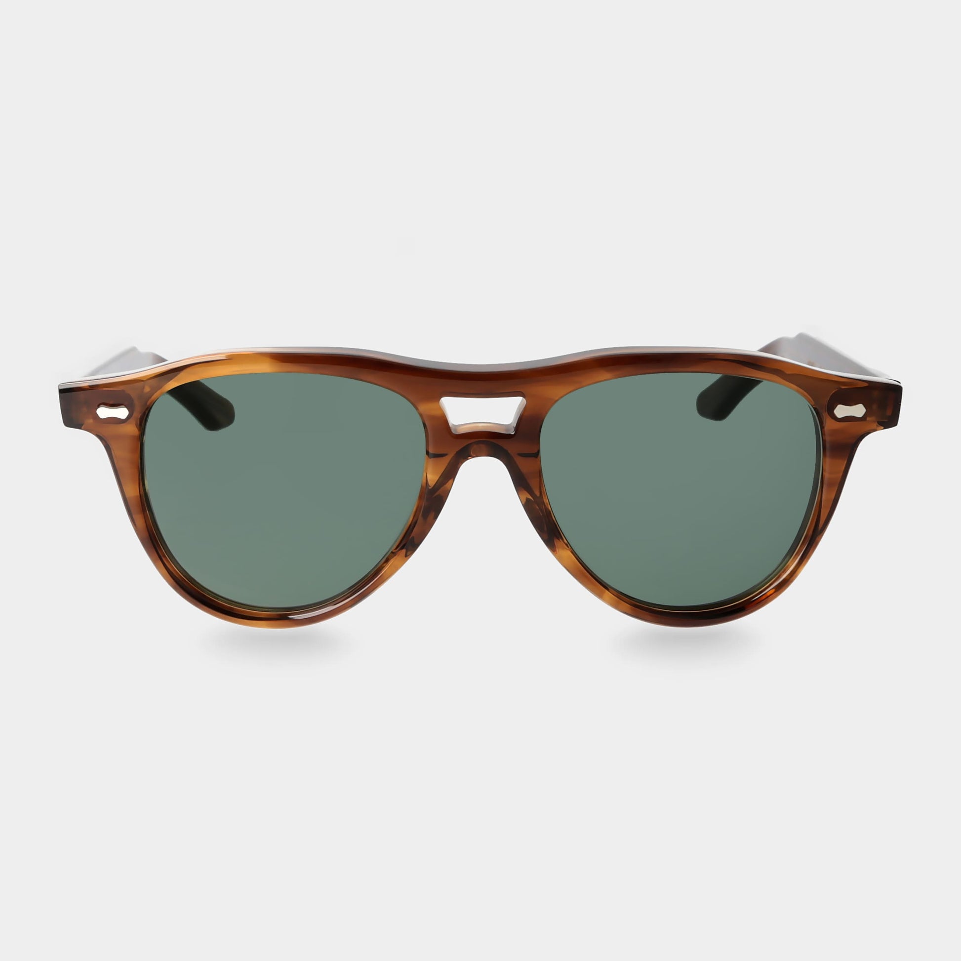 Sunglasses with tortoiseshell frame and green lenses on a light gray background. - DEI DUCHI