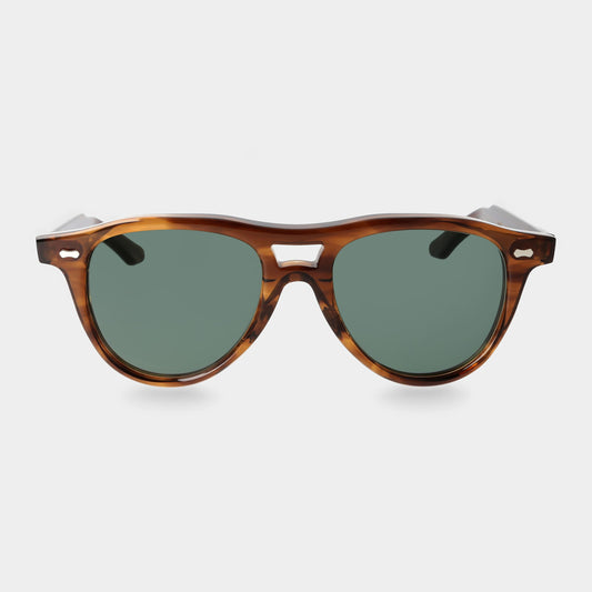 Sunglasses with tortoiseshell frame and green lenses on a light gray background. - DEI DUCHI