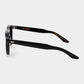 Black sunglasses with dark lenses on a light gray background. - DEI DUCHI