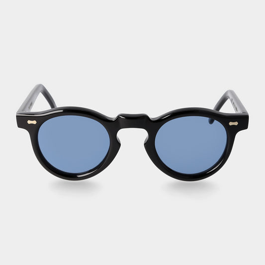 Round sunglasses with black frames and blue lenses on a light gray background. -DEI DUCHI