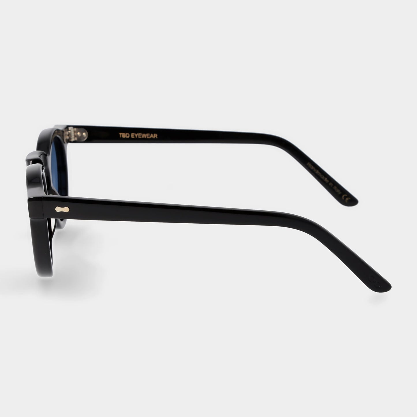 Round sunglasses with black frames and blue lenses on a light gray background. -DEI DUCHI