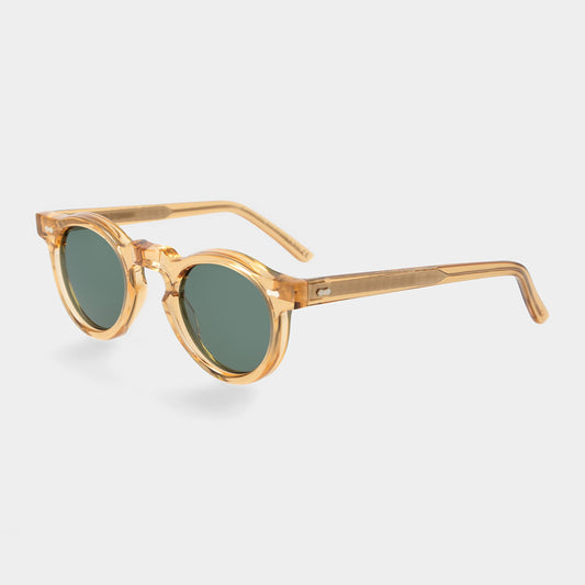 Gold-framed round sunglasses with green lenses on a light gray background. - DEI DUCHI