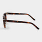 Round sunglasses with tortoiseshell frame on a light gray background. - Dei Duchi